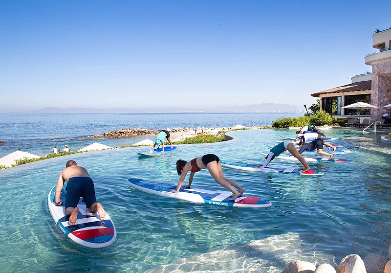 Weighted stand up paddleboards with a special sup yoga class at the beach pool
